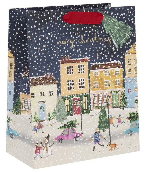 Image of a gift bag illustrated with a snowy street, houses and people and the caption merry christmas