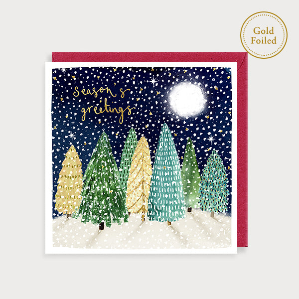 Image of illustrated christmas card with christmas trees in the snow and the caption seasons greetings