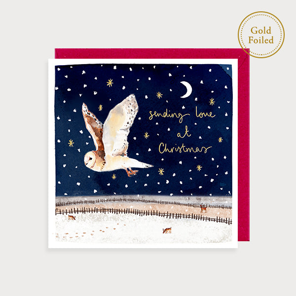 Image of illustrated foiled christmas card with a flying owl and the caption sending love at christmas