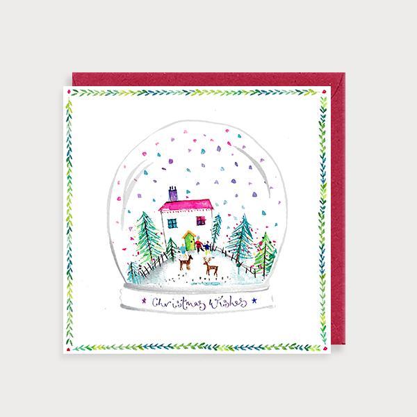 Image of illustrated christmas card with a christmas house scene in a snow globe and the caption Christmas Wishes