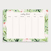 Image of illustrated weekly planner pad with a wild daisy patterned border. It has a title of Weekly Planner and has seperate boxes for the days of the week and one for the weekend
