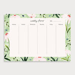 Image of illustrated weekly planner pad with a wild daisy patterned border. It has a title of Weekly Planner and has seperate boxes for the days of the week and one for the weekend