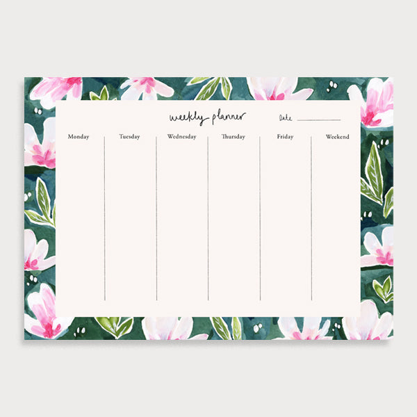 Image of illustrated weekly planner pad with a magnolia patterned border. It has a title of Weekly Planner and has seperate boxes for the days of the week and one for the weekend