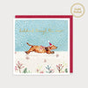 Image of illustrated christmas card with a dachshund in a christmas hat and the caption dachshund through the snow