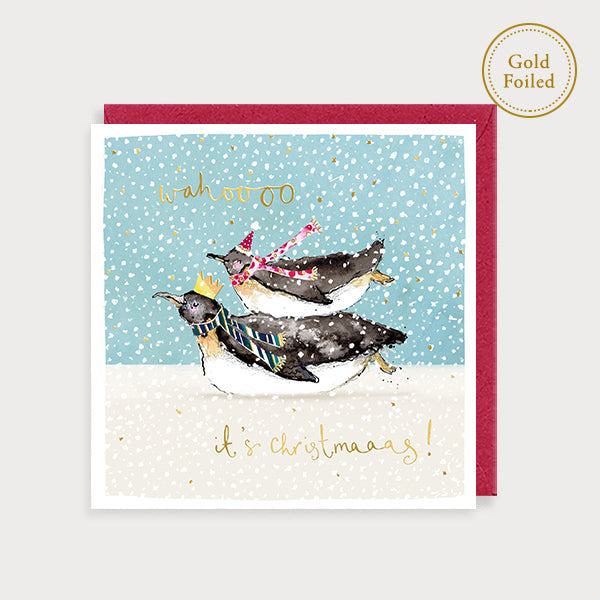 Image of illustrated foiled christmas card with two penguins in the snow and the caption wahoooo it's Christmaaas!