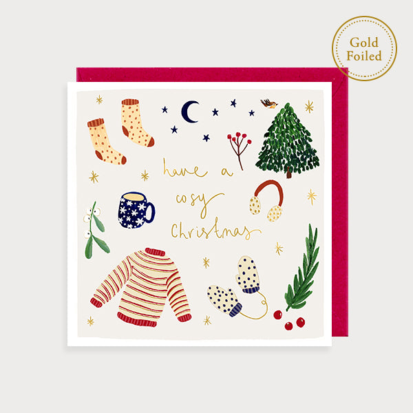 Image of illustrated foiled christmas card with pictures of socks, a jumper, mittens, a mug of tea, earmuffs and a tree and the caption have a cosy christmas